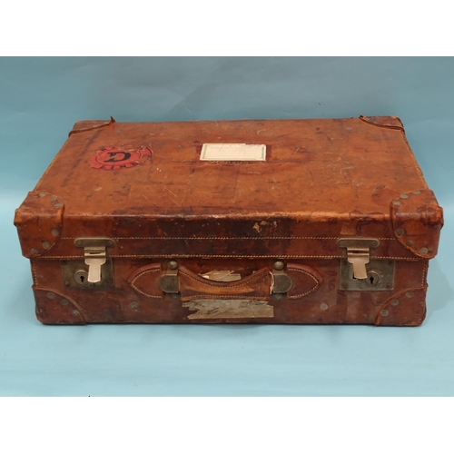 320 - A leather suitcase by J Philo, Norwich, with remains of railway labels, 62 x 42 x 20cm.... 