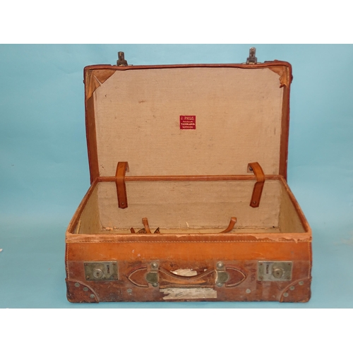 320 - A leather suitcase by J Philo, Norwich, with remains of railway labels, 62 x 42 x 20cm.... 