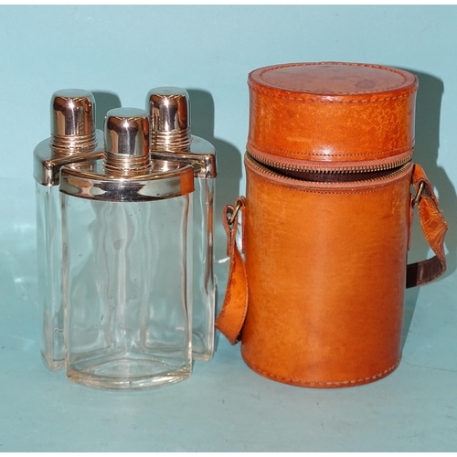 323 - A set of three travelling glass decanters with chromium-plated mounts and screw-top lids, in cylindr... 