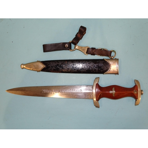 348 - A WWII German Third Reich NSKK dagger, the brown wooden grip with eagle, swastika and enamelled circ... 