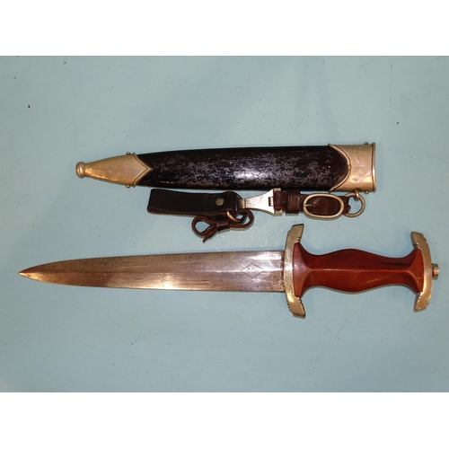 348 - A WWII German Third Reich NSKK dagger, the brown wooden grip with eagle, swastika and enamelled circ... 