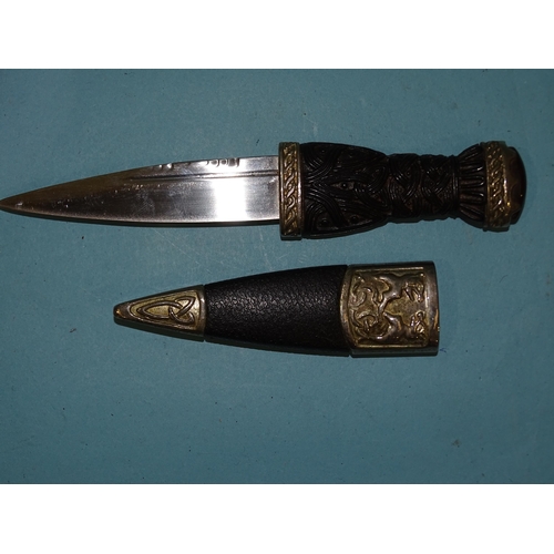 358 - A 20th century Scottish dagger (sgian dubh), the carved wood grip with metal mount, stone pommel and... 