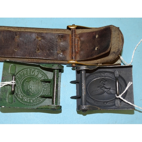 369 - A German WWII leather belt with SA belt buckle, a German army belt buckle stamped J.F.S. and a Luftw... 