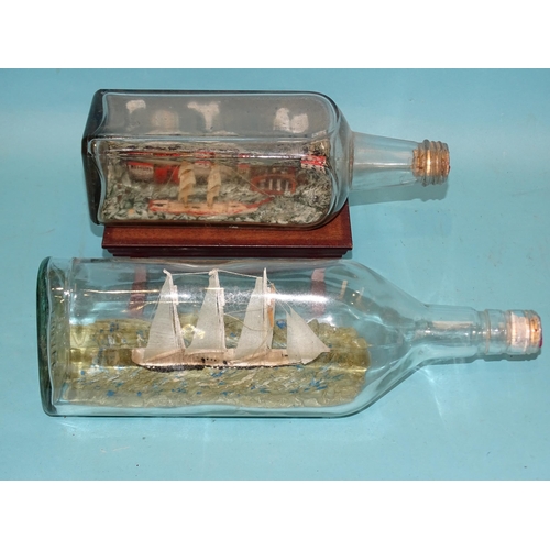 382 - A three-masted yacht in a bottle and another ship in a bottle, (2).