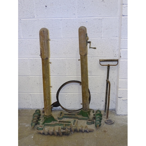 391 - A pair of 20th century wood and cast-iron tennis net posts, the cast bases marked 