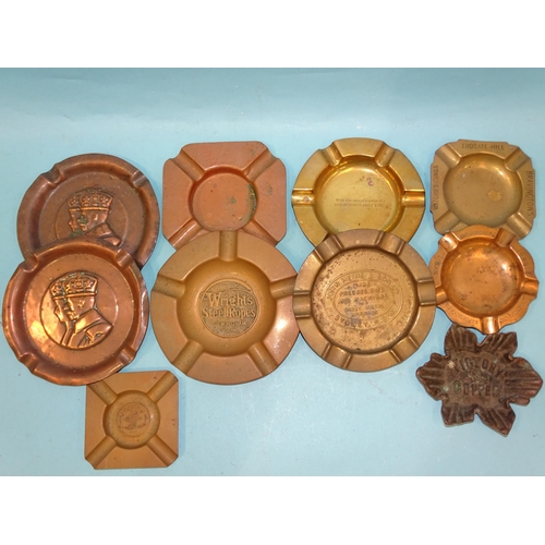 393 - A collection of nine various copper and brass commemorative and advertising ashtrays, including two ... 