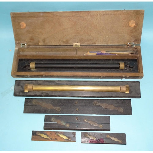 397 - A brass rolling rule in wooden case marked 