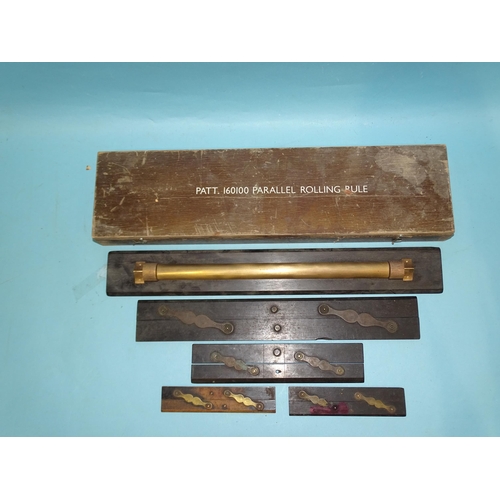 397 - A brass rolling rule in wooden case marked 