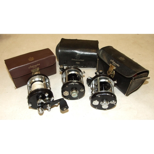 433 - An Abu Ambassadeur 6000C multiplying reel in leather case, with fittings and two others (in worn con... 