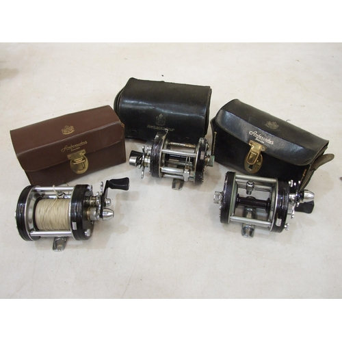 433 - An Abu Ambassadeur 6000C multiplying reel in leather case, with fittings and two others (in worn con... 