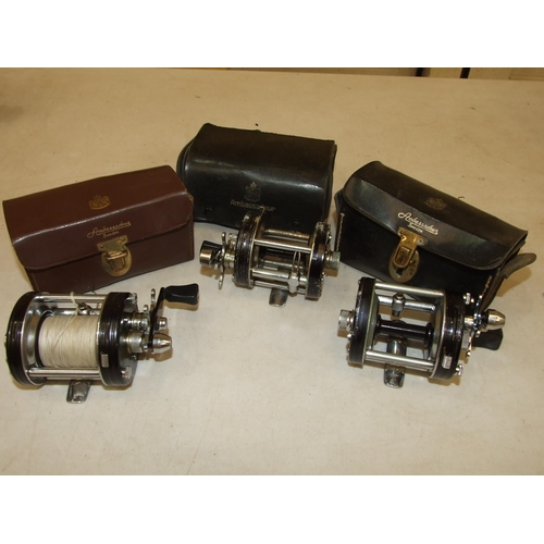 433 - An Abu Ambassadeur 6000C multiplying reel in leather case, with fittings and two others (in worn con... 