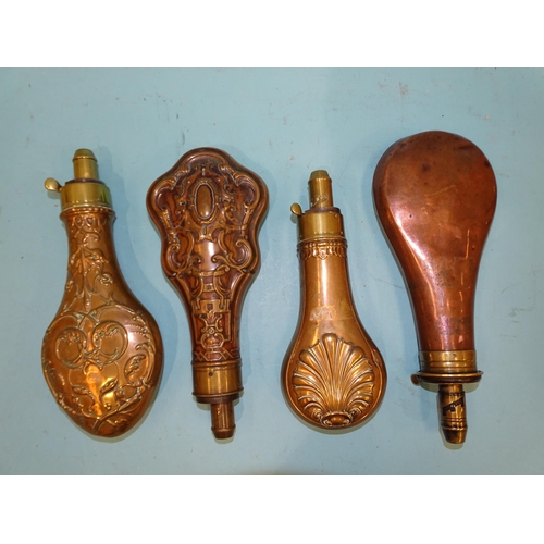 443 - A collection of four copper and brass shot and powder flasks, three with pressed decoration, one by ... 