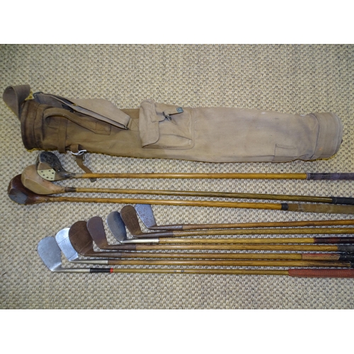 446 - An early-20th century canvas felt bag of three woods and seven irons; six hickory-shafted and one me... 