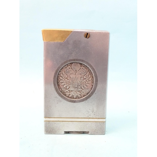 72 - An unusual trench art-style aluminium and brass table lighter inset on each side a Marie Therese tha... 