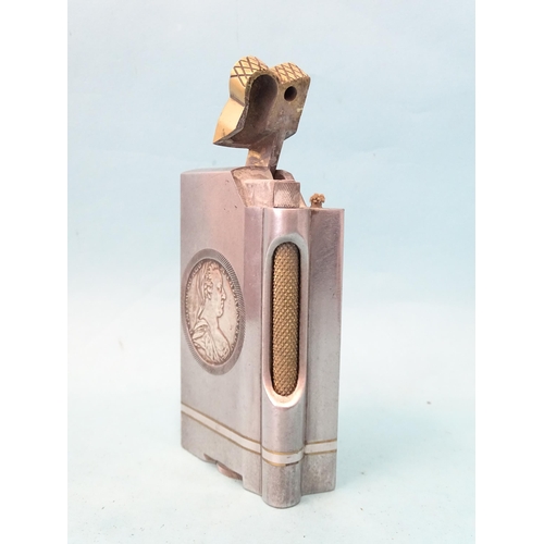 72 - An unusual trench art-style aluminium and brass table lighter inset on each side a Marie Therese tha... 