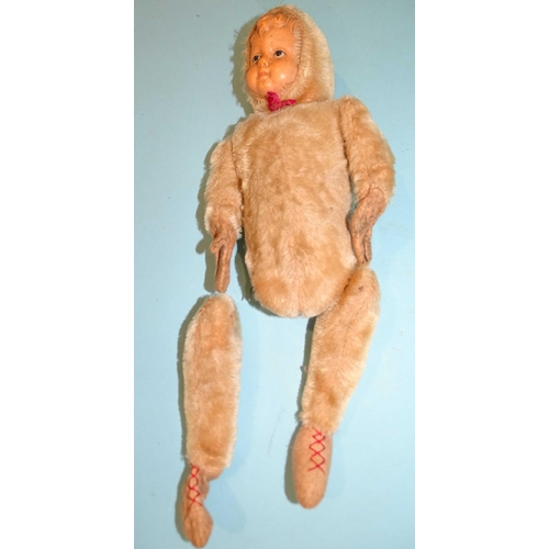 82 - An early-20th century doll, with celluloid face and plush-covered head, jointed body and limbs, with... 