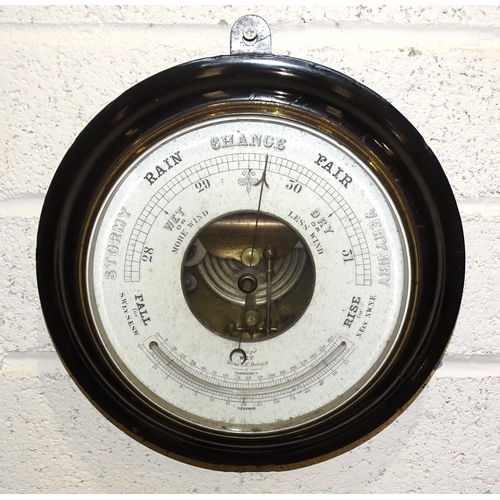 23 - A circular aneroid barometer with Reaumur thermometer, in ebonised wood frame, 28cm diameter and sev... 