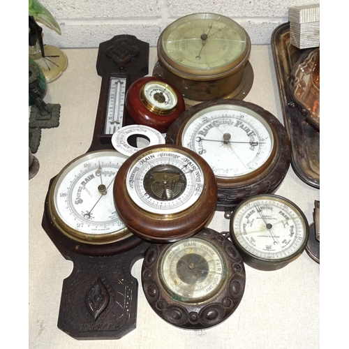 23 - A circular aneroid barometer with Reaumur thermometer, in ebonised wood frame, 28cm diameter and sev... 