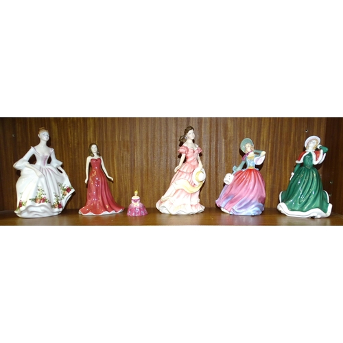 57 - A collection of five Royal Doulton figurines: Christmas Day HN5097, Autumn Breeze HN4716, Amy HN3854... 