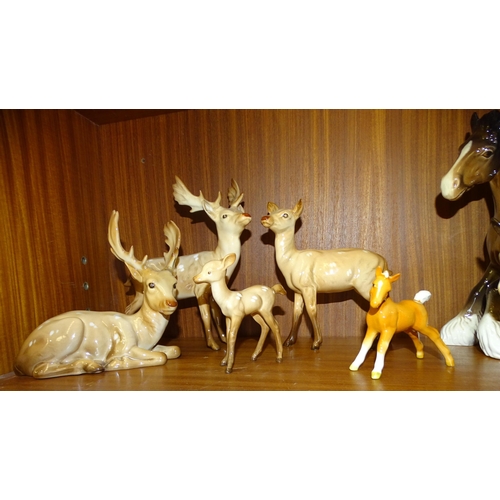 60 - A Beswick deer family, comprising Stag-Standing (part of antler re-glued), Stag-Lying (one antler re... 