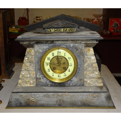 63 - A late-19th century slate and marble mantel clock in the Egyptian style, of tapering form, the movem... 