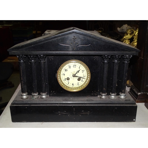 63 - A late-19th century slate and marble mantel clock in the Egyptian style, of tapering form, the movem... 