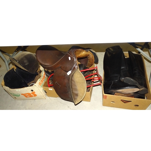 86 - Two pairs of black leather riding boots, size 7, a leather saddle, bridle and other riding accessori... 