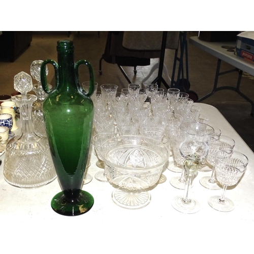 131 - A tall green glass footed amphora shape bottle, 33.5cm high, two cut-glass wine/sherry decanters, a ... 