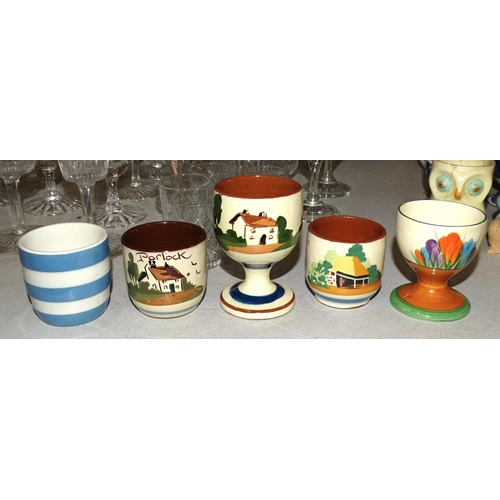 132 - A Clarice Cliff Bizarre 'Crocus' pattern eggcup, three Watcombe Torquay examples, a TG Green Cornish... 