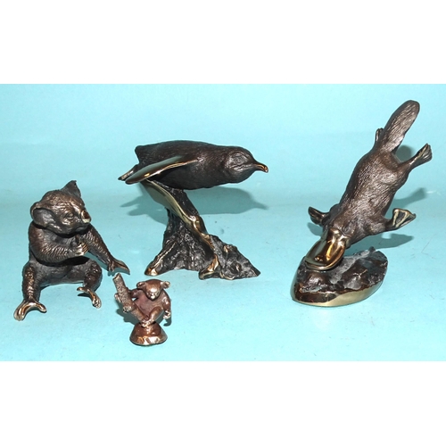 142 - In the style of Mary Michelmore, a collection of three bronze animal studies: a duck-billed platypus... 