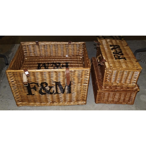 6 - A group of four wicker Fortnum & Mason picnic hampers with carrying handles and leather straps, ... 