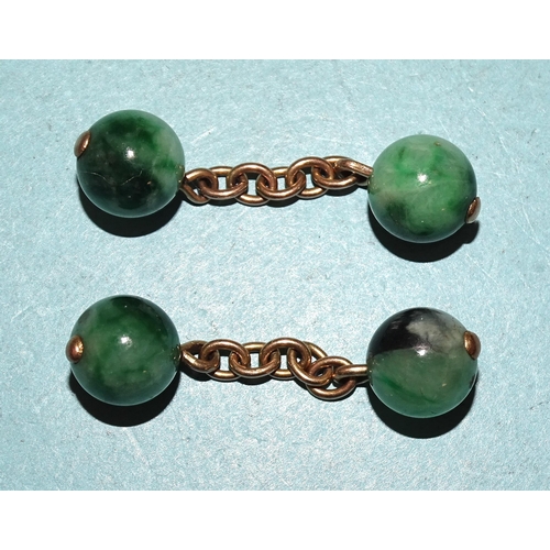 429 - A pair of jade ball cufflinks, on unmarked chains, each ball 9.5mm diameter, 8g.