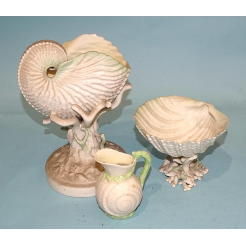 130 - A Belleek nautilus shell raised on a coral-form base, 23cm high, black printed mark, another clam sh... 