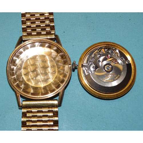 298 - Cyma, a 9ct gold automatic wrist watch, the gilt dial with date aperture at '3' and baton numerals, ... 