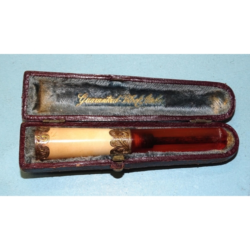 355 - A meerschaum and amber cheroot holder with 9ct gold mounts, (boxed).