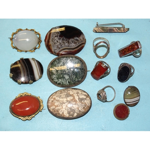 356 - Two silver rings set hardstones, one set amber and various hardstone brooches, mainly a/f.... 