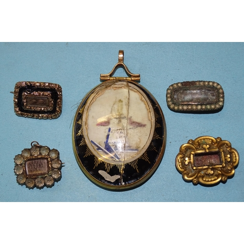 373 - An early-19th century oval mourning pendant depicting a lamp between two doves, with hair locket to ... 