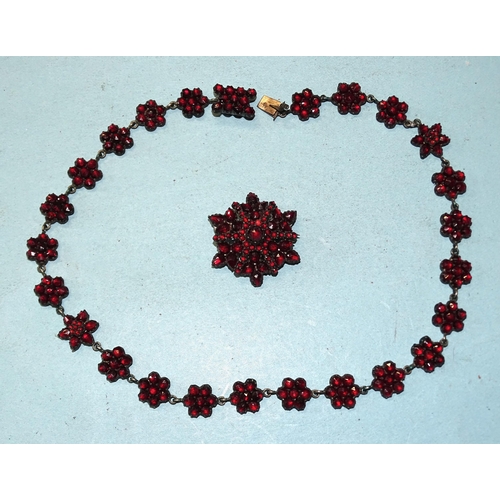 393 - A Victorian Bohemian garnet necklace of flowerhead clusters, 37cm long and a similar brooch, 3cm wid... 