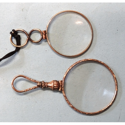 394 - A 19th century gilt-metal quizzing glass and a gold-plated monocle, (2).