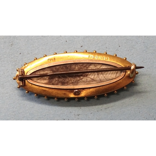 410 - A Victorian 15ct gold locket-back brooch of marquise form, set a ruby and two rose-cut diamond point... 