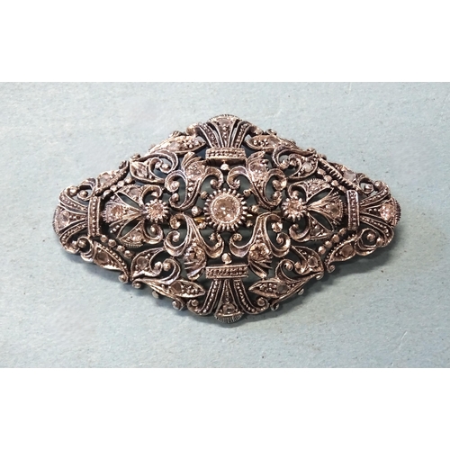 413 - A late-19th century silver and gold plaque brooch set old brilliant and rose-cut diamonds, in a scro... 