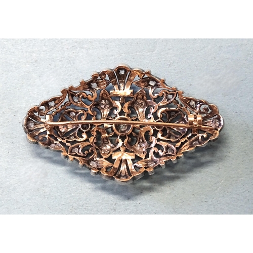 413 - A late-19th century silver and gold plaque brooch set old brilliant and rose-cut diamonds, in a scro... 