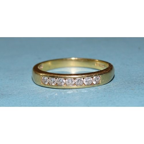 424 - An 18ct gold ring channel-set seven brilliant-cut diamonds, total diamond weight approximately 0.35c... 