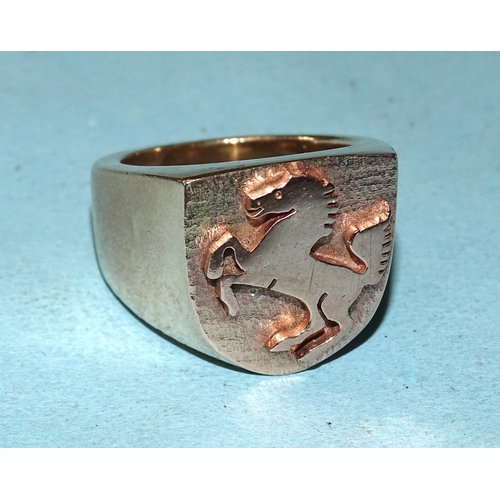 433 - A large yellow gold ring with raised Ferrari horse motif on shield, marked '9ct', size U, 34.5g.... 