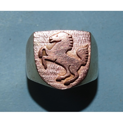 433 - A large yellow gold ring with raised Ferrari horse motif on shield, marked '9ct', size U, 34.5g.... 