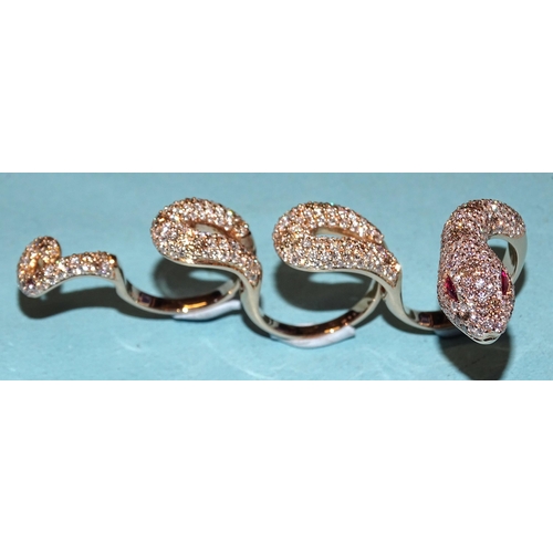 451 - An impressive four-finger ring in the form of a snake pavé-set white diamonds interspersed wi... 