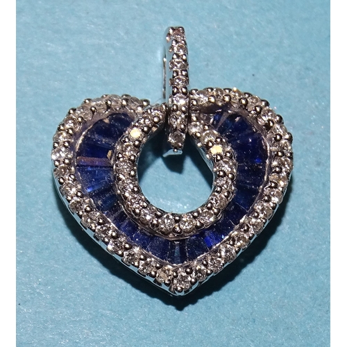 452 - A small 18ct white gold heart-shaped pendant set calibre-cut sapphires outlined with diamond points,... 