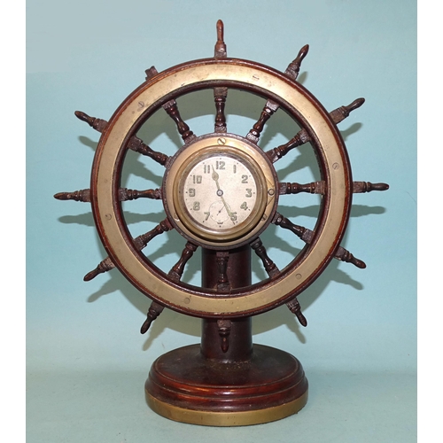 48 - A novelty table clock in the form of a twelve-spoke ship's wheel, now with central bezel wind moveme... 