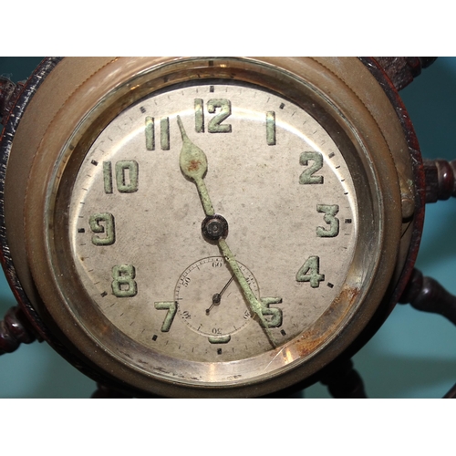 48 - A novelty table clock in the form of a twelve-spoke ship's wheel, now with central bezel wind moveme... 