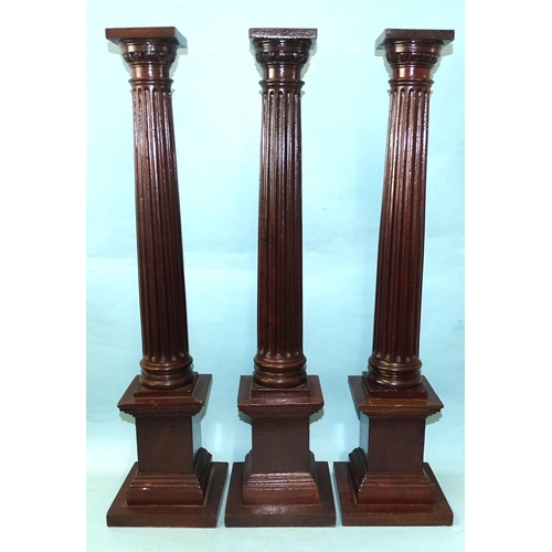 87 - A group of three mahogany Masonic fluted pillars, 63cm high, (3).